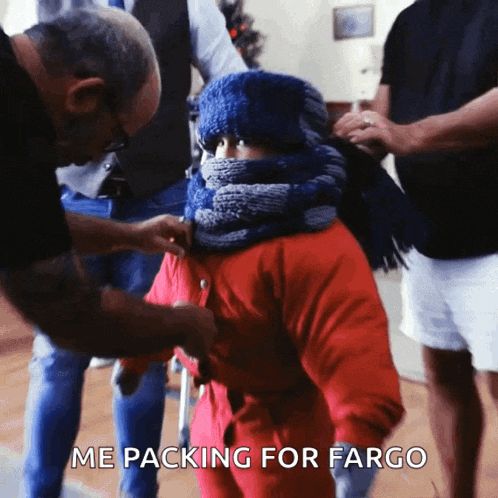 a man helps a child with a scarf around their neck with the words me packing for fargo below it