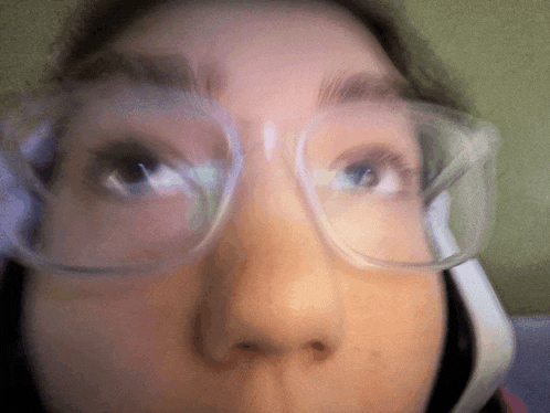 a close up of a person 's face with glasses