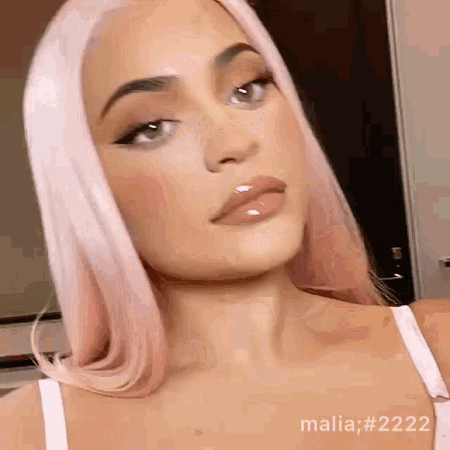 a close up of a woman 's face with the hashtag malia # 2222 at the bottom