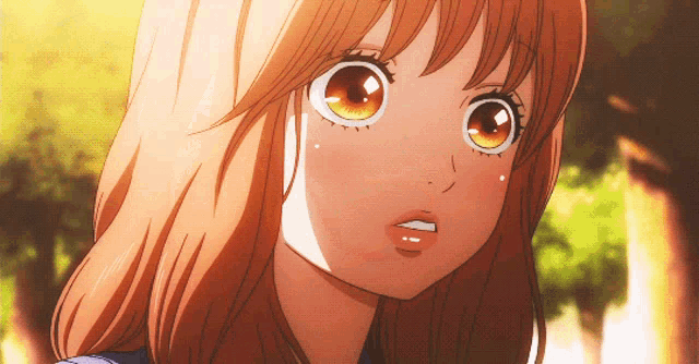 a close up of a girl 's face with big brown eyes