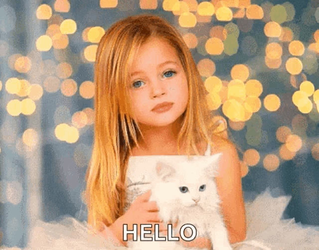 a little girl is holding a white cat and says hello in the corner