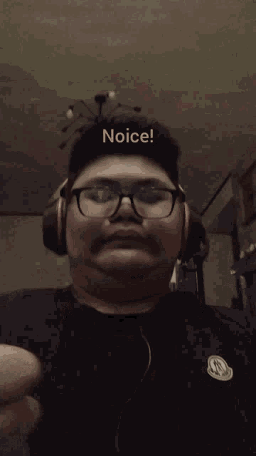 a man wearing glasses and headphones is giving a thumbs up with the word noice written above him