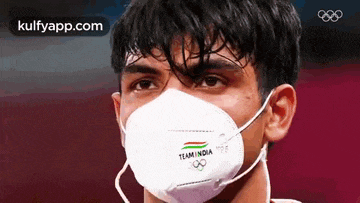 a man wearing a mask that says team india on it .
