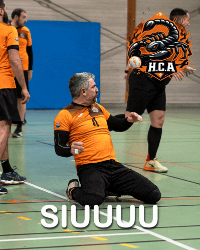 a man kneeling on the floor with a h.c.a. logo on his shirt