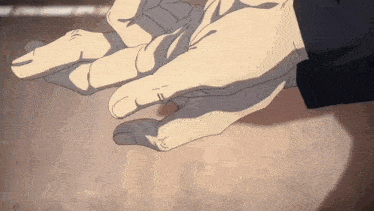 a close up of a person 's hands with a ring on their finger .
