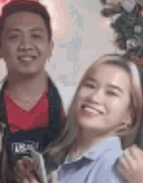 a man and a woman are standing next to each other and smiling .