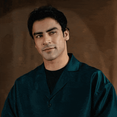 a man wearing a green jacket and a black shirt