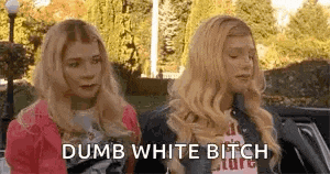 two blonde women are sitting next to each other in a car and talking .