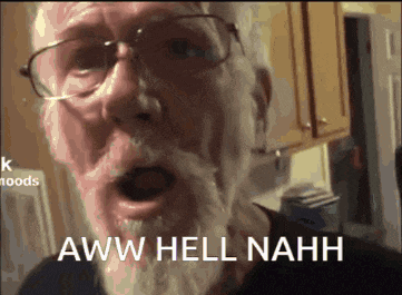 a man with glasses and a beard is saying " aww hell nahh "