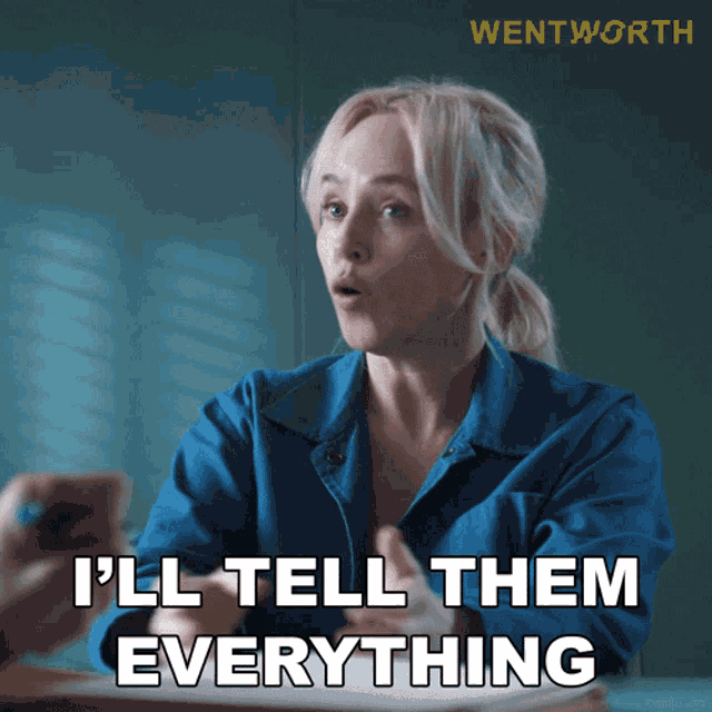a woman in a blue shirt is sitting at a table and says i 'll tell them everything