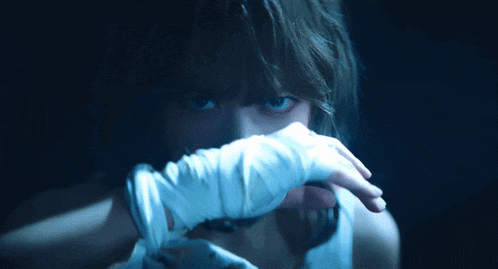a close up of a person 's face with white gloves on