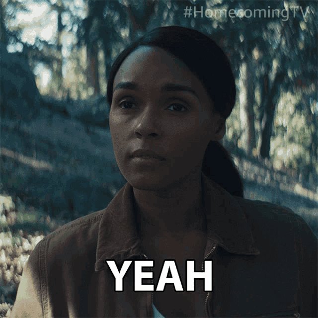 a woman in a brown jacket says " yeah " in front of a forest