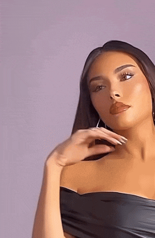 a woman is wearing a black off the shoulder top and earrings