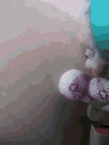 a person wearing purple and white slippers is standing on a floor .