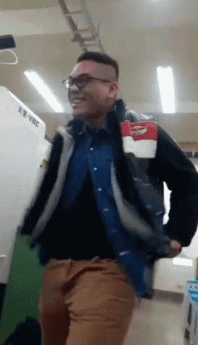 a man is dancing in front of a machine that says vmc on it