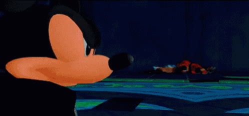 a cartoon of mickey mouse standing on a green field