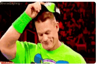 a pixelated image of a man wearing a green shirt and sunglasses