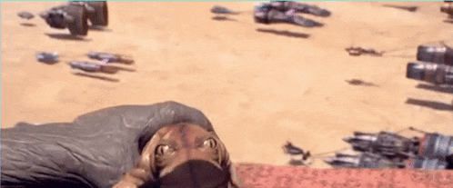 a person laying on the ground with a bunch of vehicles in the background .
