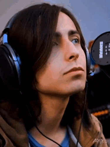 a close up of a person wearing headphones .