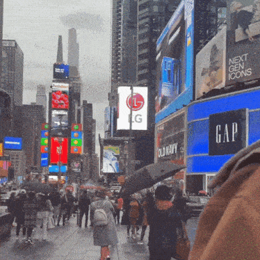 a busy city street with a gap and lg sign in the background