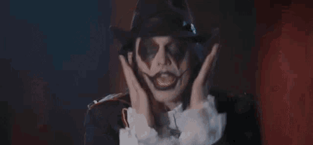 a man in a clown costume is holding up his hands