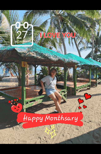 a woman sits on a bench on a beach with a happy monthary sign