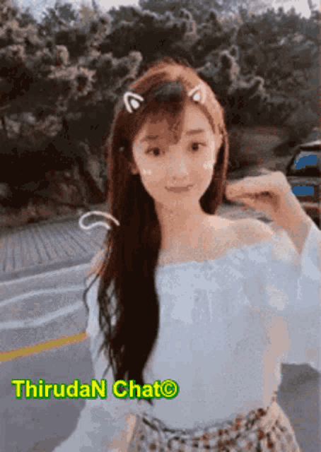 a girl with cat ears on her head is wearing a white shirt