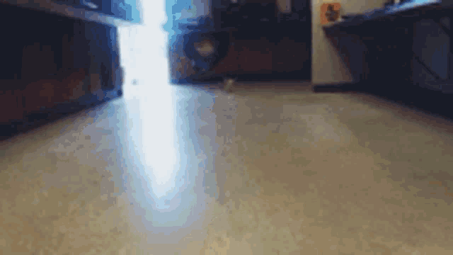 a blurry picture of a person walking on a tiled floor .