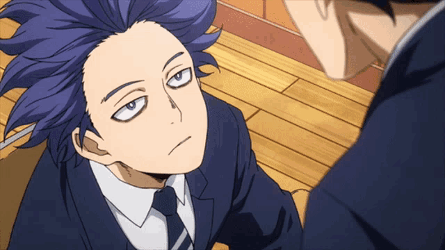 a man with purple hair and a suit and tie