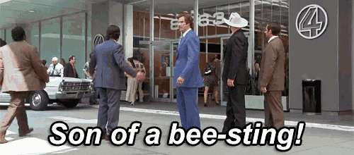 a man in a blue suit stands in front of a building with the words son of a bee-sting