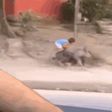 a blurry picture of a person riding a bike in the dirt .