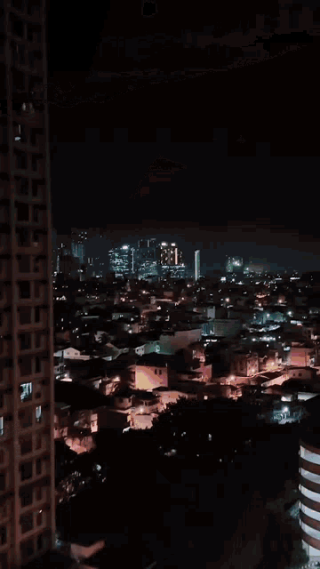a night time view of a city with a few buildings lit up