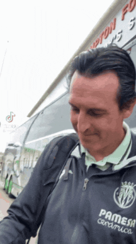 a man wearing a jacket that says pamesa ceramica on it