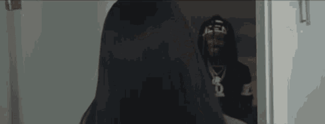 a man and a woman are standing next to each other in a hallway .