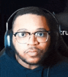 a man wearing glasses and headphones is making a face .