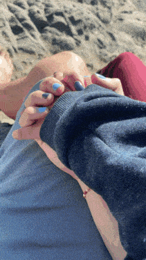 a person holding another person 's hand on the beach