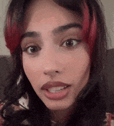 a close up of a woman 's face with red streaks