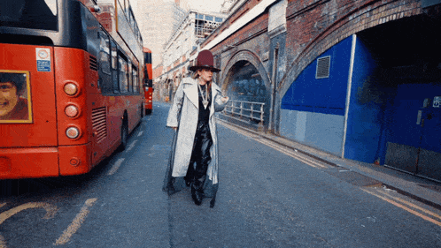 a red double decker bus has a sign on the back that says no parking