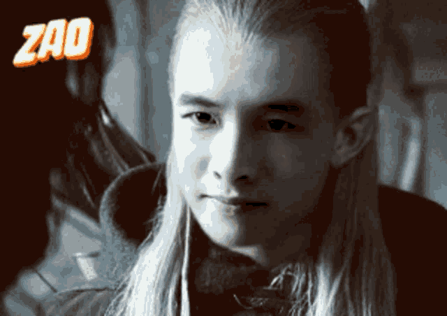 a man with long blonde hair and the word zao on the bottom right