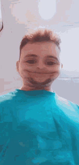a man in a blue shirt is making a face with his mouth open