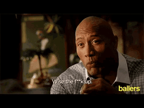 a bald man in a plaid shirt says wise the f * ck up