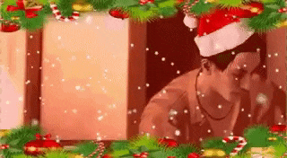 a man wearing a santa hat is standing in front of a window with christmas decorations .