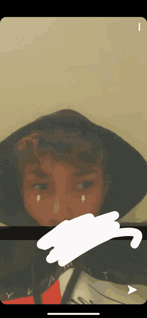 a young boy wearing a black hoodie has lightning bolts on his face