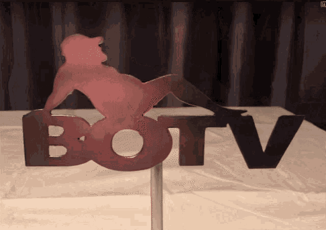 a sign that says botv with a silhouette of a woman on it
