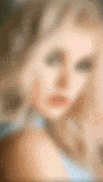 a blurred image of a woman 's face with a necklace around her neck