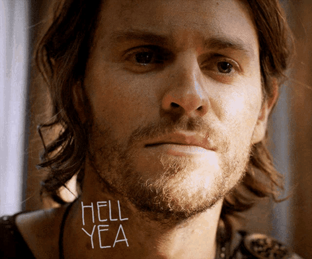 a close up of a man with the words hell yea on his neck
