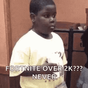 a young boy is holding a video game controller and saying `` fortnite over 2k never '' .