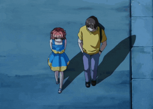 a boy and a girl are walking down a street