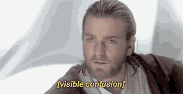 a man with a beard says " visible confusion " in front of a white background