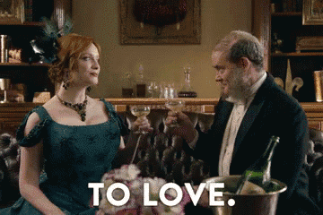 a man and a woman are toasting with champagne and the words to love are visible